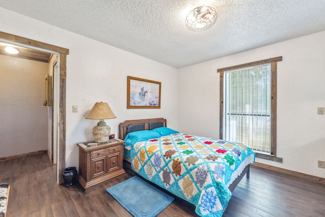 106 Hillcroft Dr, Weatherford, TX 76087 - bedroom with dark wood-type flooring, baseboards, and a textured ceiling