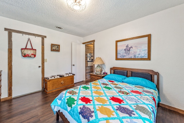106 Hillcroft Dr, Weatherford, TX 76087 - bedroom featuring dark wood-style flooring, a textured ceiling, and baseboards