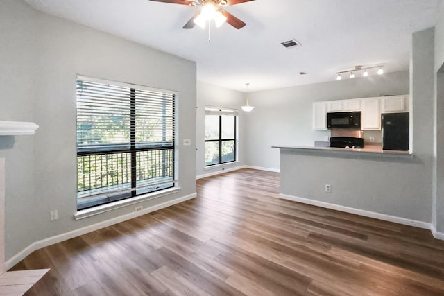 7340 Skillman St Unit 1109, Dallas, TX 75231 - unfurnished living room with ceiling fan, wood finished floors, and baseboards