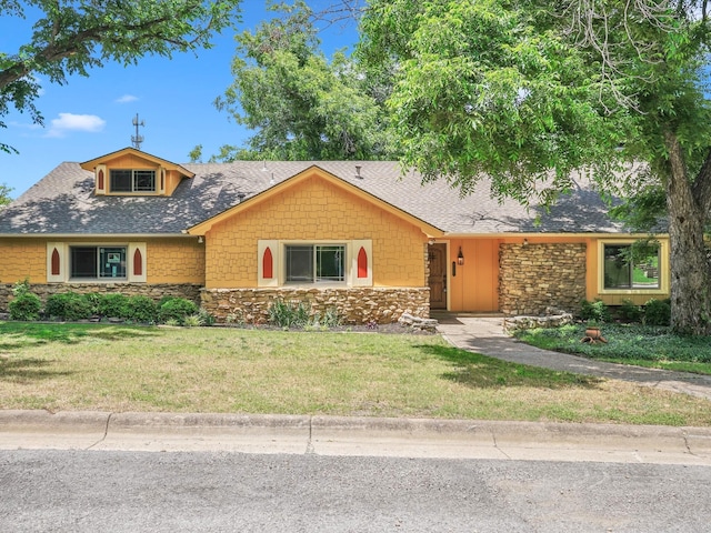 5217 Blue Valley Ct, Fort Worth, TX 76112 - view of front facade with stone siding, a front yard, and a shingled roof