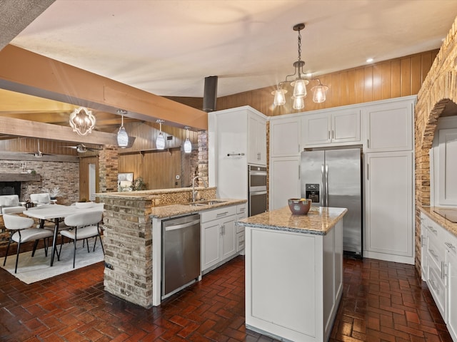 5217 Blue Valley Ct, Fort Worth, TX 76112 - kitchen with appliances with stainless steel finishes, a sink, brick floors, open floor plan, and light stone counters