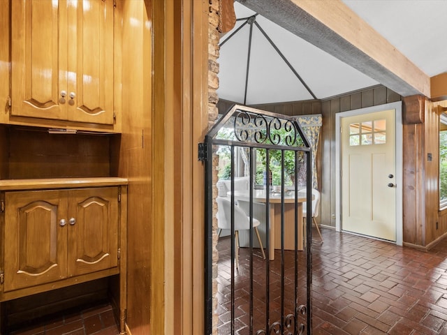 5217 Blue Valley Ct, Fort Worth, TX 76112 - foyer featuring wooden walls, brick floors, and baseboards