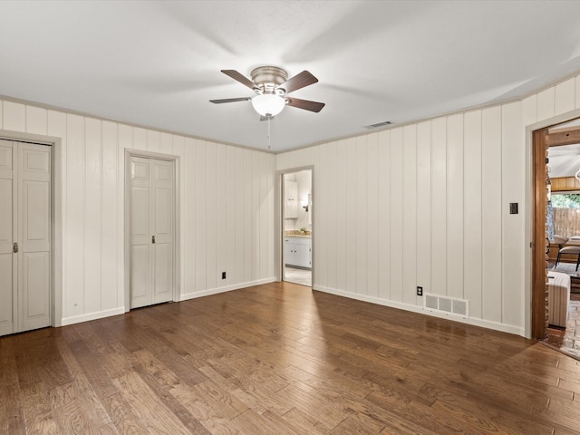 5217 Blue Valley Ct, Fort Worth, TX 76112 - unfurnished bedroom featuring hardwood / wood-style flooring, two closets, ceiling fan, and baseboards