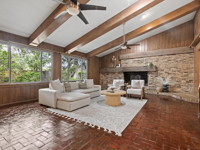 5217 Blue Valley Ct, Fort Worth, TX 76112 - living room with a ceiling fan, wooden walls, brick flooring, and a fireplace