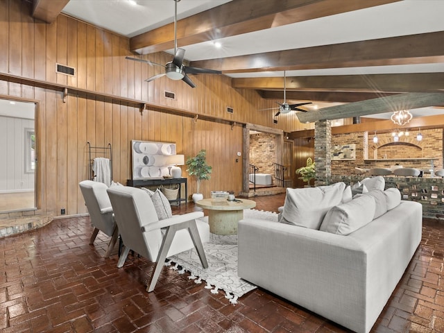 5217 Blue Valley Ct, Fort Worth, TX 76112 - living area with wooden walls, a ceiling fan, beamed ceiling, and brick floors
