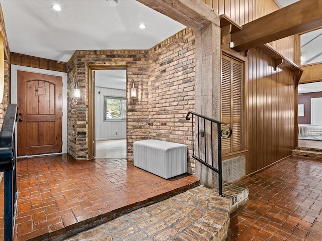 5217 Blue Valley Ct, Fort Worth, TX 76112 - entryway with brick floors, wooden walls, and recessed lighting