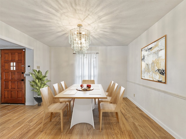 3146 Oak Hill Rd, Carrollton, TX 75007 - dining room with a chandelier, light wood-type flooring, and baseboards