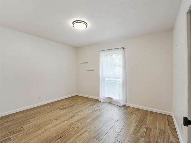 3146 Oak Hill Rd, Carrollton, TX 75007 - spare room featuring light wood-style floors and baseboards