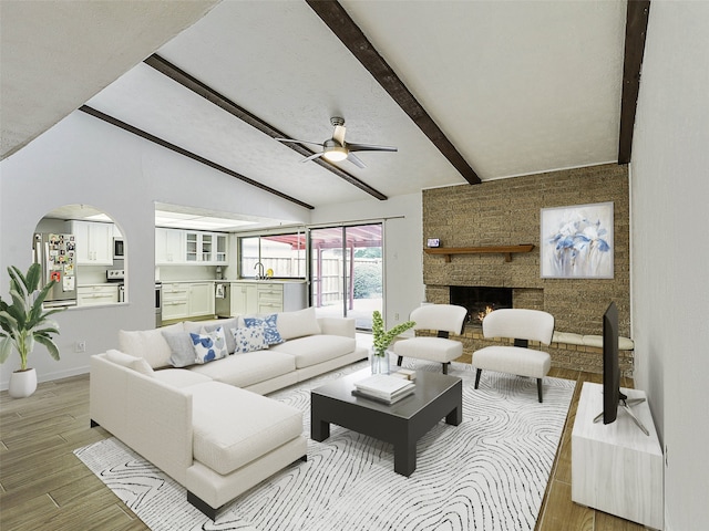 3146 Oak Hill Rd, Carrollton, TX 75007 - living area with a ceiling fan, baseboards, light wood-type flooring, a stone fireplace, and arched walkways