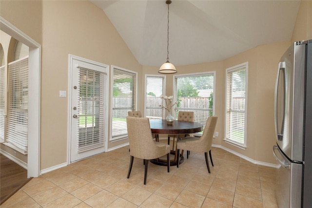 6233 Roaring Springs Dr, North Richland Hills, TX 76180 - dining room featuring vaulted ceiling, baseboards, and light tile patterned flooring