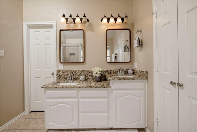 6233 Roaring Springs Dr, North Richland Hills, TX 76180 - bathroom featuring double vanity, a stall shower, tile patterned floors, and baseboards