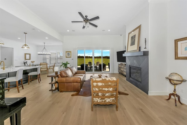 277 Schneider Rd, Sherman, TX 75090 - living area featuring a tiled fireplace, light wood finished floors, a ceiling fan, recessed lighting, and crown molding