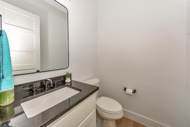 277 Schneider Rd, Sherman, TX 75090 - bathroom featuring vanity, toilet, wood finished floors, and baseboards