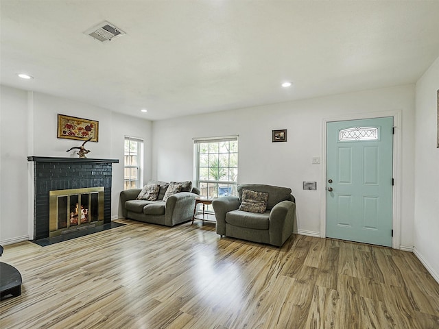 2522 W Jefferson Blvd, Dallas, TX 75211 - living room featuring wood finished floors, a brick fireplace, recessed lighting, and baseboards
