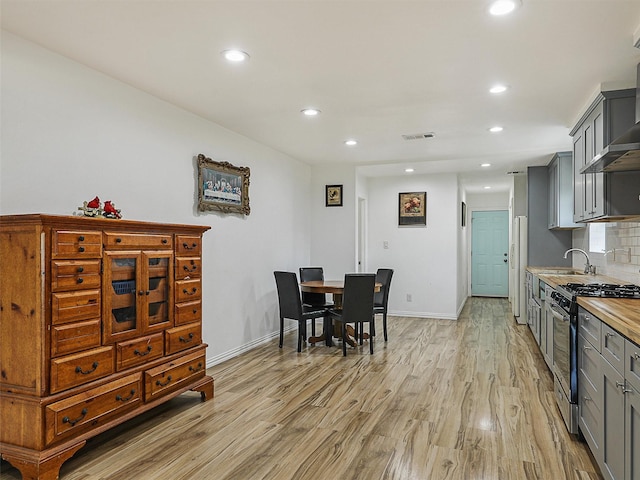 2522 W Jefferson Blvd, Dallas, TX 75211 - dining room with recessed lighting, light wood finished floors, and baseboards