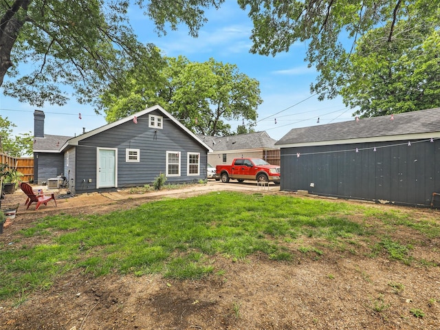 2522 W Jefferson Blvd, Dallas, TX 75211 - rear view of property featuring a lawn and a chimney