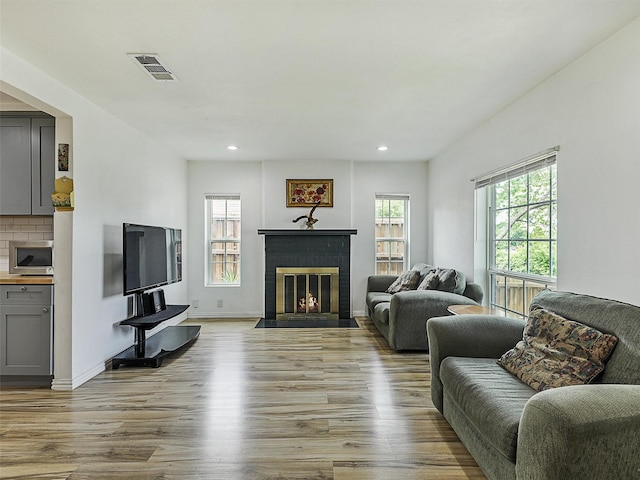 2522 W Jefferson Blvd, Dallas, TX 75211 - living area with a fireplace, wood finished floors, and recessed lighting