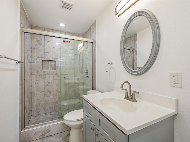 2522 W Jefferson Blvd, Dallas, TX 75211 - full bathroom with vanity, toilet, a shower stall, and tile patterned flooring