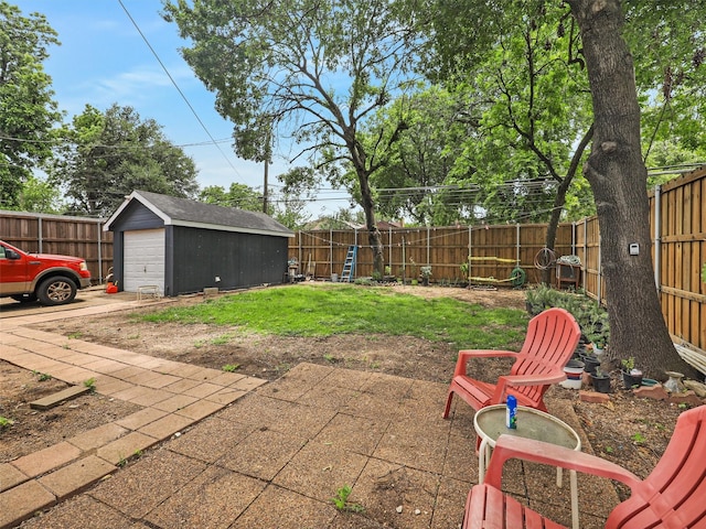 2522 W Jefferson Blvd, Dallas, TX 75211 - fenced backyard with a garage, an outdoor structure, concrete driveway, and grilling area