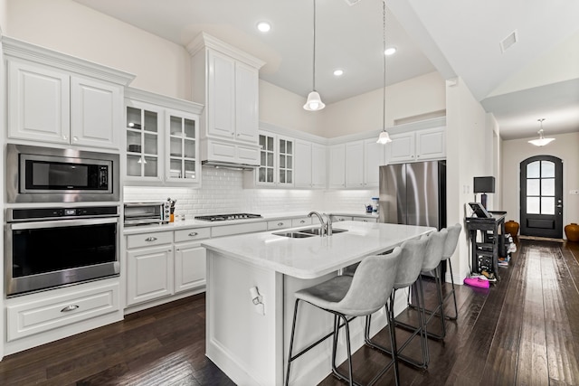 2712 Cross Oak Pl, Mckinney, TX 75071 - kitchen with stainless steel appliances, a sink, glass insert cabinets, and white cabinetry