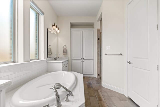 2712 Cross Oak Pl, Mckinney, TX 75071 - full bathroom with plenty of natural light, vanity, a bath, and wood finished floors