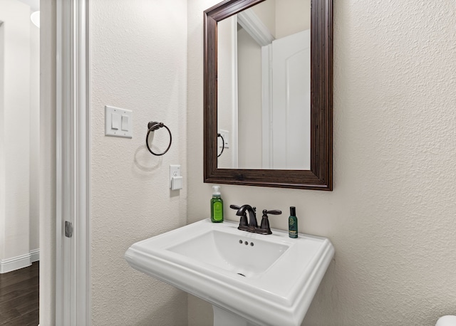 2712 Cross Oak Pl, Mckinney, TX 75071 - bathroom featuring a textured wall, a sink, and wood finished floors