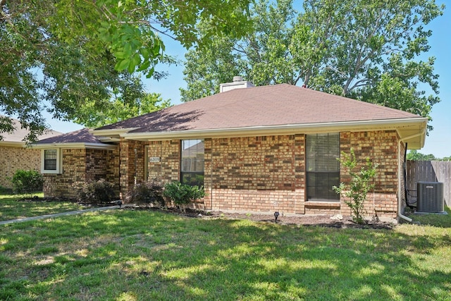 6319 Leasa Ct, Sachse, TX 75048 - view of front of house with brick siding, a chimney, central AC, and roof with shingles