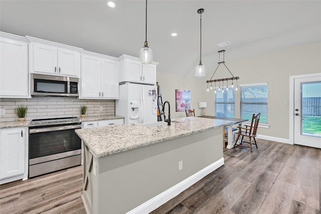 4817 Enclave Dr, Sanger, TX 76266 - kitchen with stainless steel appliances, a sink, tasteful backsplash, white cabinetry, and light wood-style floors