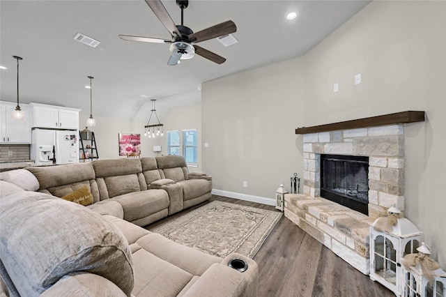 4817 Enclave Dr, Sanger, TX 76266 - living area with a ceiling fan, dark wood finished floors, a fireplace, baseboards, and vaulted ceiling