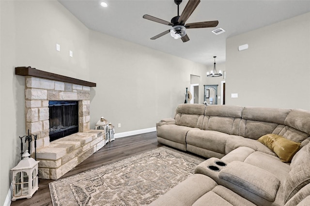 4817 Enclave Dr, Sanger, TX 76266 - living area with ceiling fan, dark wood-type flooring, a chandelier, a stone fireplace, and baseboards