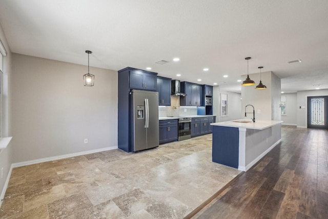 3804 Kathryn Way, Mckinney, TX 75070 - kitchen featuring stainless steel appliances, a sink, wall chimney exhaust hood, blue cabinetry, and light countertops