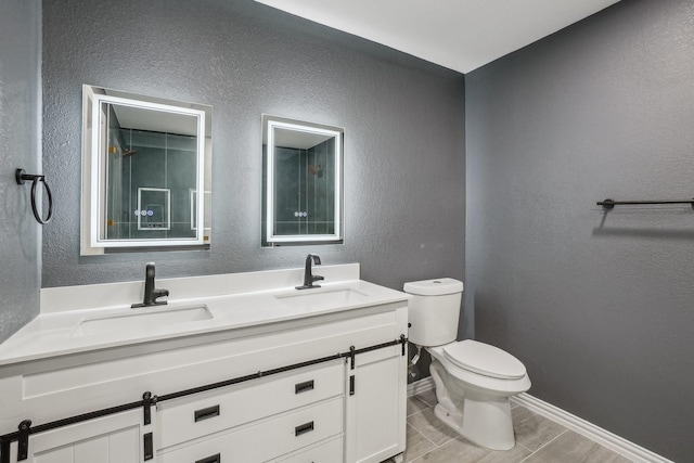 3804 Kathryn Way, Mckinney, TX 75070 - bathroom featuring a textured wall, toilet, double vanity, and baseboards