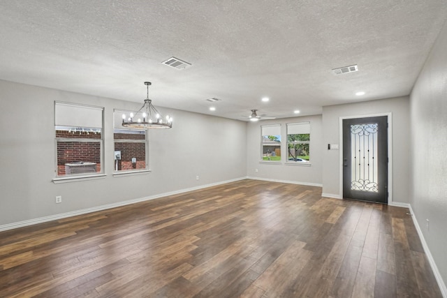 3804 Kathryn Way, Mckinney, TX 75070 - foyer entrance with ceiling fan, a textured ceiling, dark wood-type flooring, baseboards, and a chandelier