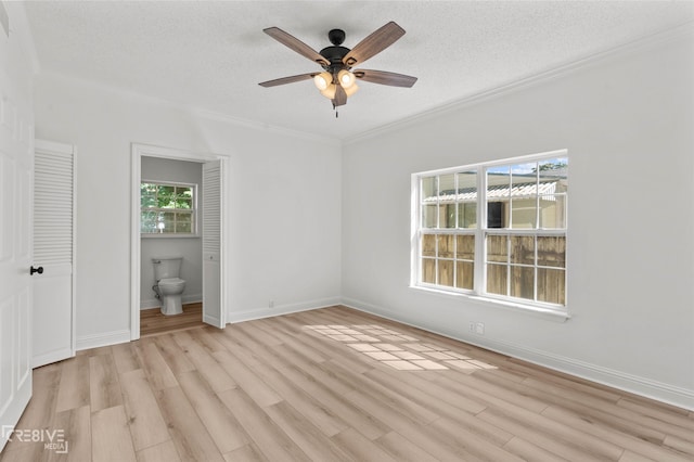 123 Carrollton Ave, Shreveport, LA 71105 - unfurnished bedroom with light wood finished floors, crown molding, a textured ceiling, baseboards, and ensuite bath