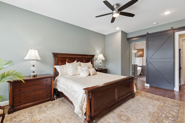 15198 Woodbluff Dr, Frisco, TX 75035 - bedroom featuring a barn door, wood finished floors, recessed lighting, and ceiling fan