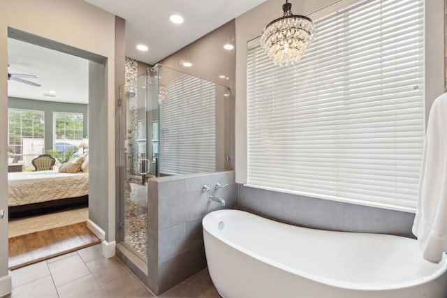 15198 Woodbluff Dr, Frisco, TX 75035 - ensuite bathroom with a freestanding bath, a stall shower, tile patterned flooring, recessed lighting, and a chandelier