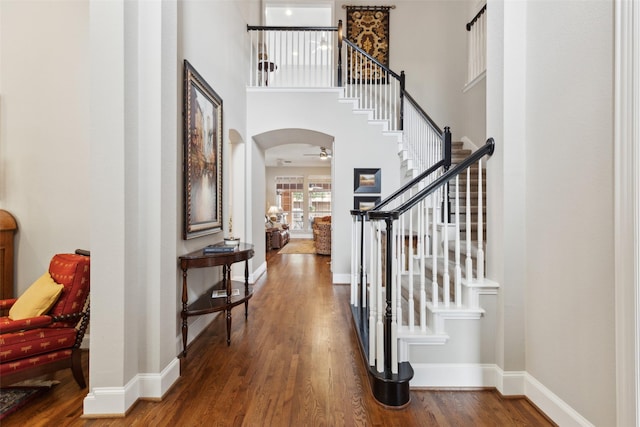 15198 Woodbluff Dr, Frisco, TX 75035 - entrance foyer with wood finished floors, stairs, arched walkways, and a towering ceiling