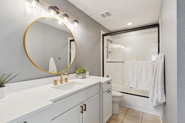 15198 Woodbluff Dr, Frisco, TX 75035 - bathroom with vanity, toilet, tile patterned flooring, combined bath / shower with glass door, and a textured wall