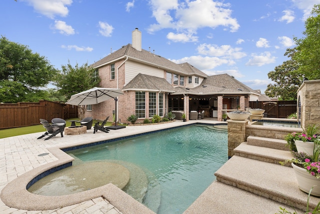 15198 Woodbluff Dr, Frisco, TX 75035 - view of swimming pool featuring a fire pit, a patio area, and a fenced backyard