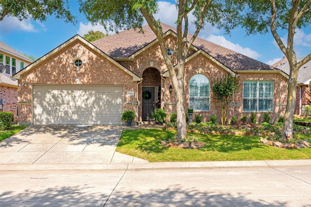 414 Long Cove Dr, Fairview, TX 75069 - view of front of house featuring brick siding, an attached garage, driveway, a shingled roof, and a front lawn