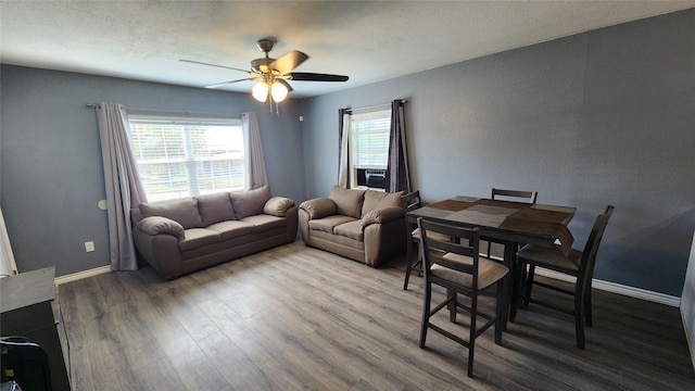 809 Bowie St, Sweetwater, TX 79556 - living room with ceiling fan, wood finished floors, baseboards, and cooling unit