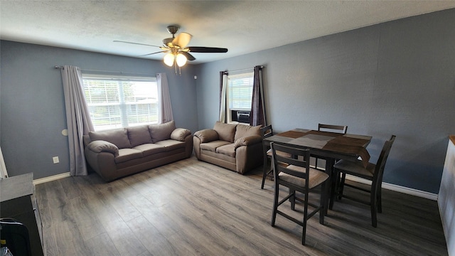 809 Bowie St, Sweetwater, TX 79556 - living room featuring ceiling fan, wood finished floors, baseboards, and a textured ceiling