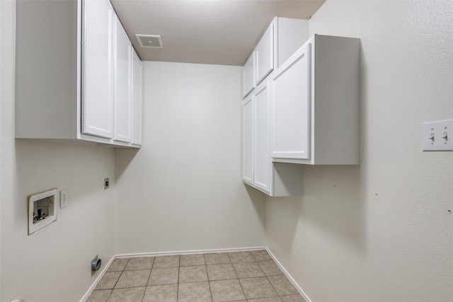 1337 Red River Ln, Allen, TX 75002 - laundry room featuring cabinet space, hookup for a washing machine, electric dryer hookup, light tile patterned floors, and baseboards