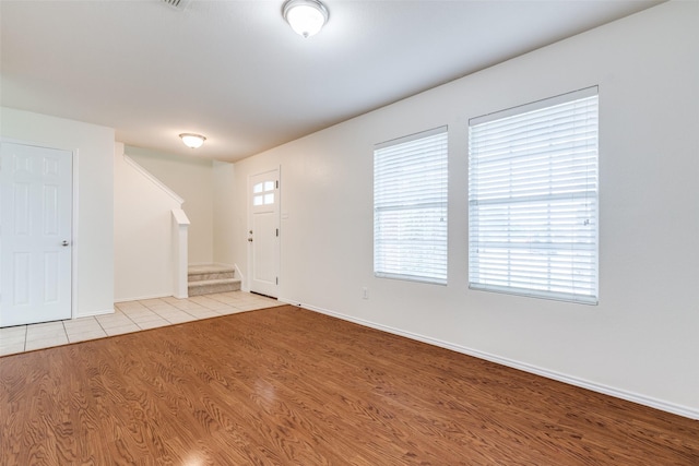1337 Red River Ln, Allen, TX 75002 - entrance foyer with stairway, light wood finished floors, and baseboards
