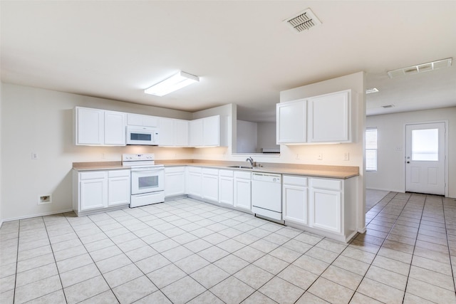 1337 Red River Ln, Allen, TX 75002 - kitchen featuring white appliances, a sink, light countertops, light tile patterned floors, and white cabinets