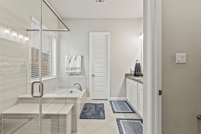 3456 Begonia Ln, Irving, TX 75038 - bathroom with a bath, a shower stall, vanity, and baseboards
