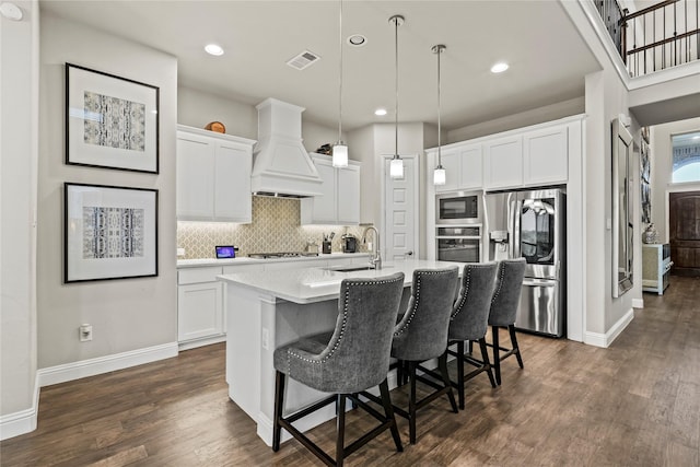 3456 Begonia Ln, Irving, TX 75038 - kitchen featuring appliances with stainless steel finishes, custom range hood, a sink, light countertops, and decorative backsplash