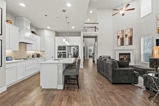 3456 Begonia Ln, Irving, TX 75038 - kitchen featuring open floor plan, stainless steel refrigerator with ice dispenser, built in microwave, ceiling fan, and premium range hood