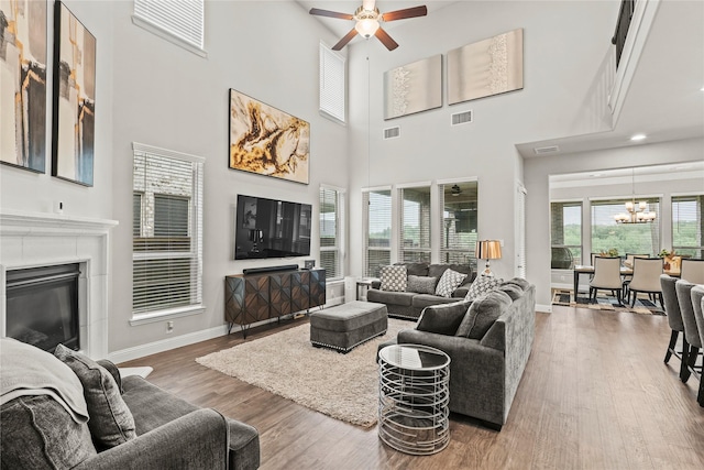 3456 Begonia Ln, Irving, TX 75038 - living area with a ceiling fan, a chandelier, baseboards, wood finished floors, and a towering ceiling