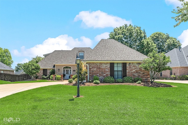 9653 Catawba Dr, Shreveport, LA 71115 - french provincial home featuring brick siding, driveway, and roof with shingles